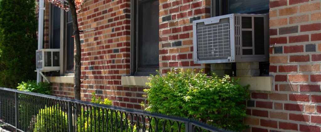 Outdoor window air conditioning units on an old New York City brick apartment