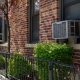 Outdoor window air conditioning units on an old New York City brick apartment