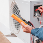 a man is working on an air conditioner