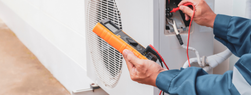 a man is working on an air conditioner