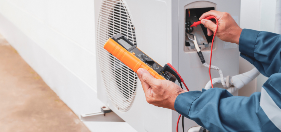 a man is working on an air conditioner